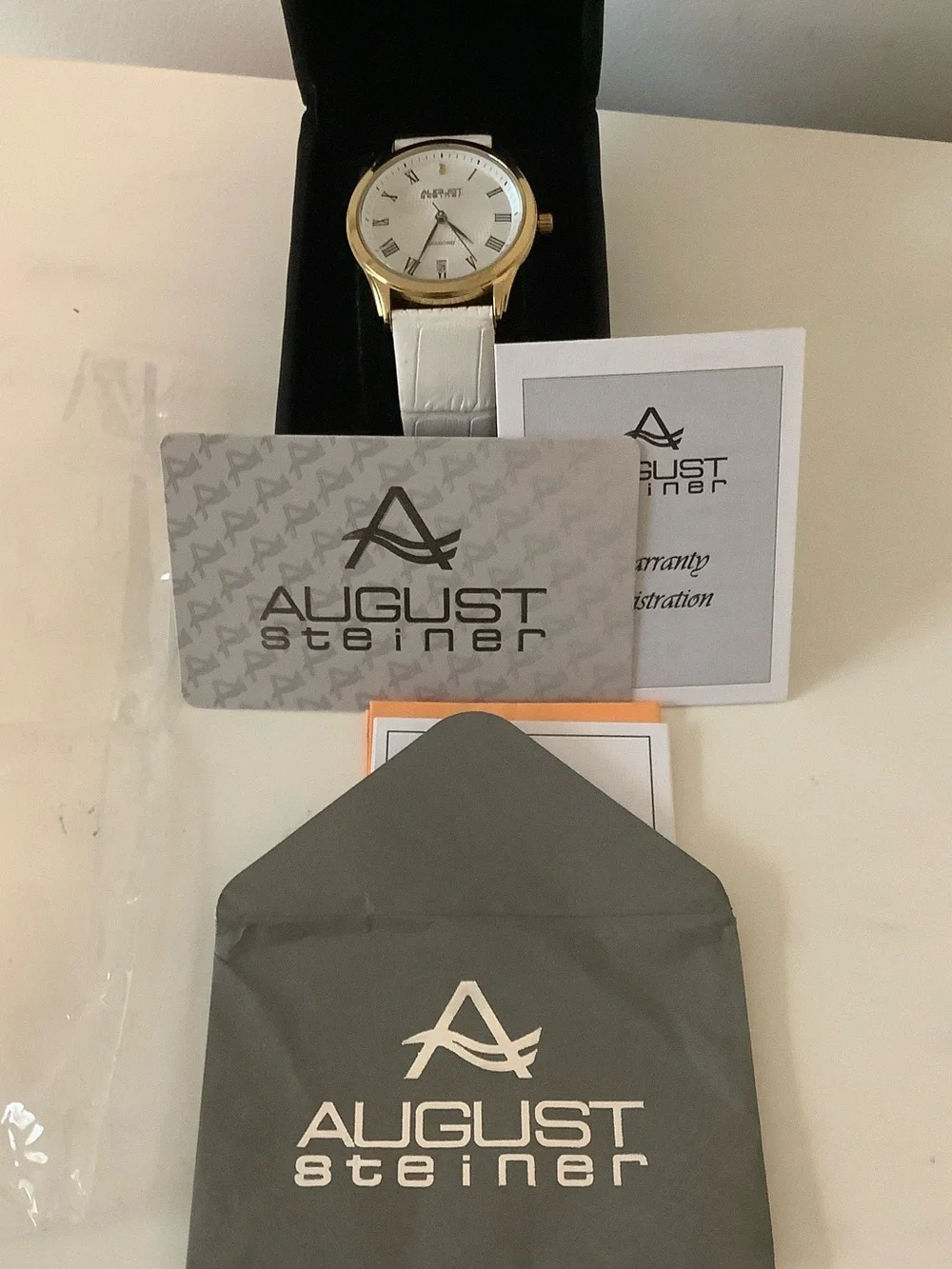 August Steiner diamond watch. New. White leather band.